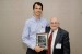 Dr. Nagib Callaos, General Chair, giving Dr. Kevin Foltz a plaque "In Appreciation for Delivering a Great Keynote Address at a Plenary Session."